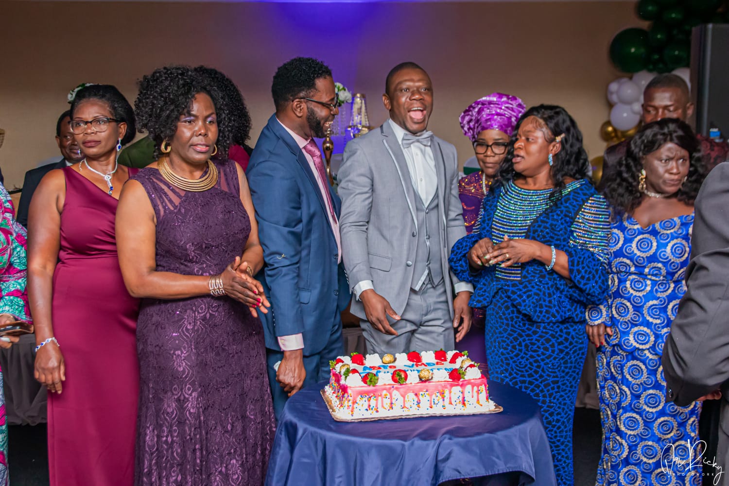 Members gathered around the anniversary cake